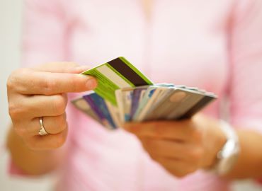 Picture of an individual holding credit cards