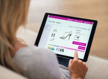Women shopping for shoes on laptop