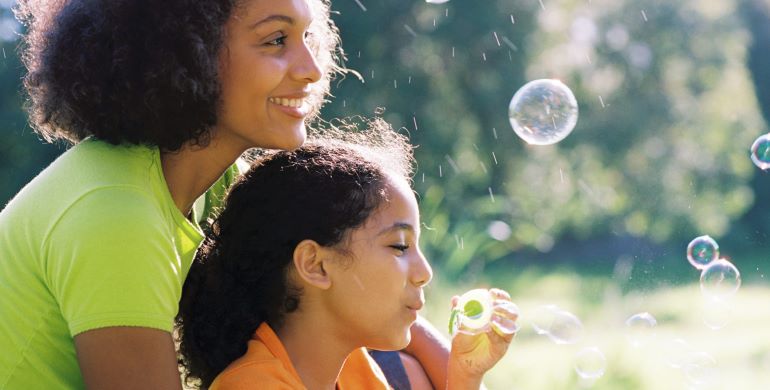 Mom and daughter blowing bubbles