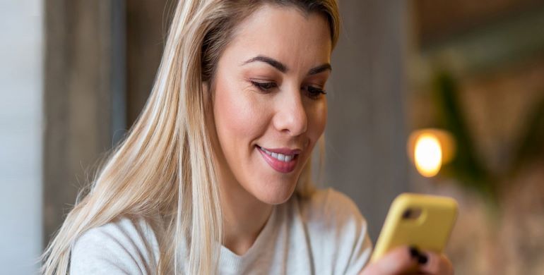 Woman typing on phone