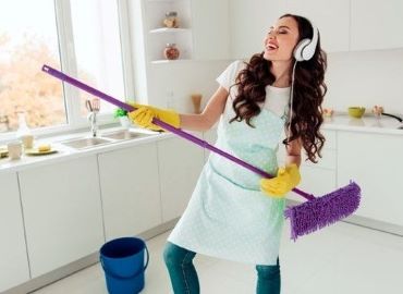 Picture of women dancing with a mop