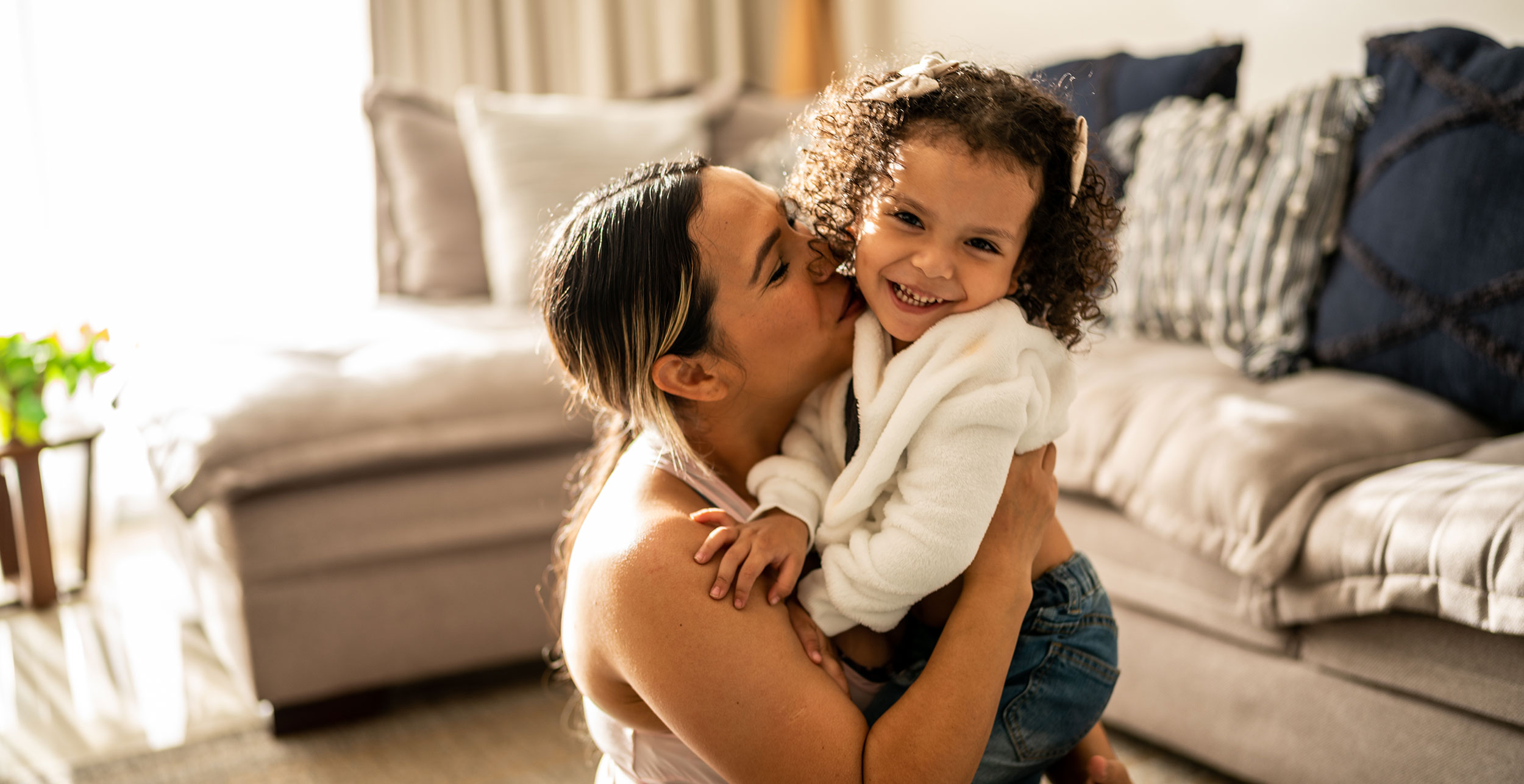 Young woman hugging young person