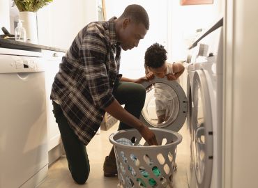 Father and son doing laundry together