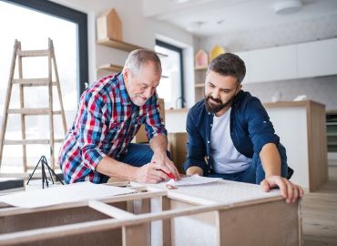 Adult son with father working on a house project