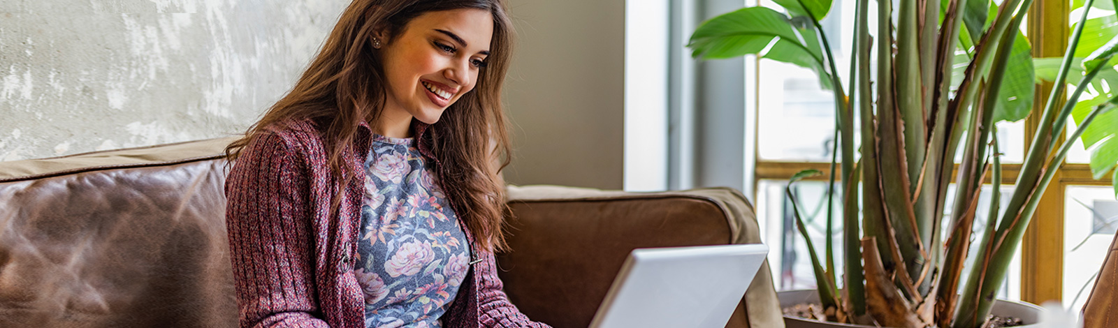 Woman on laptop, smiling