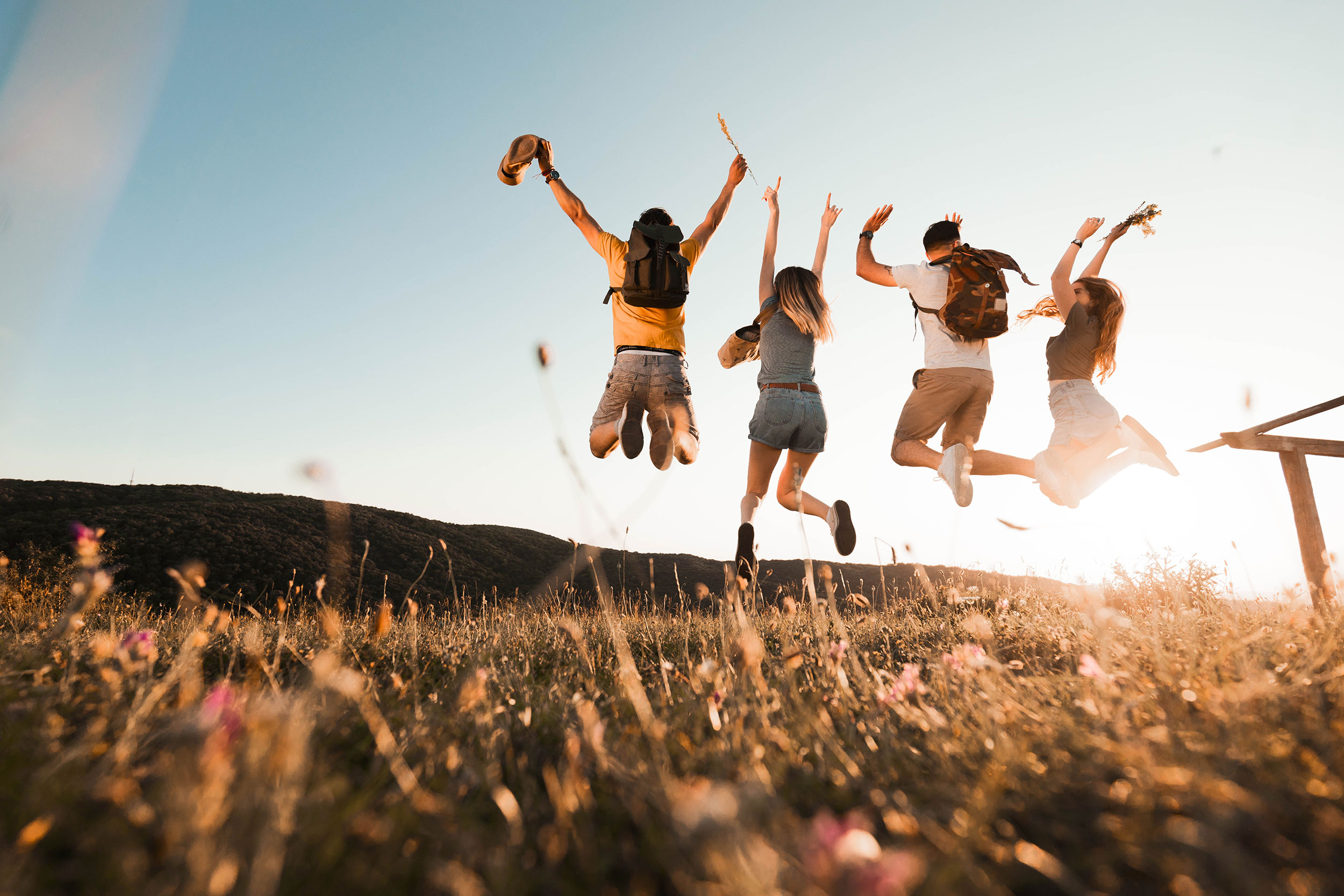 Group of people jumping in the air outside
