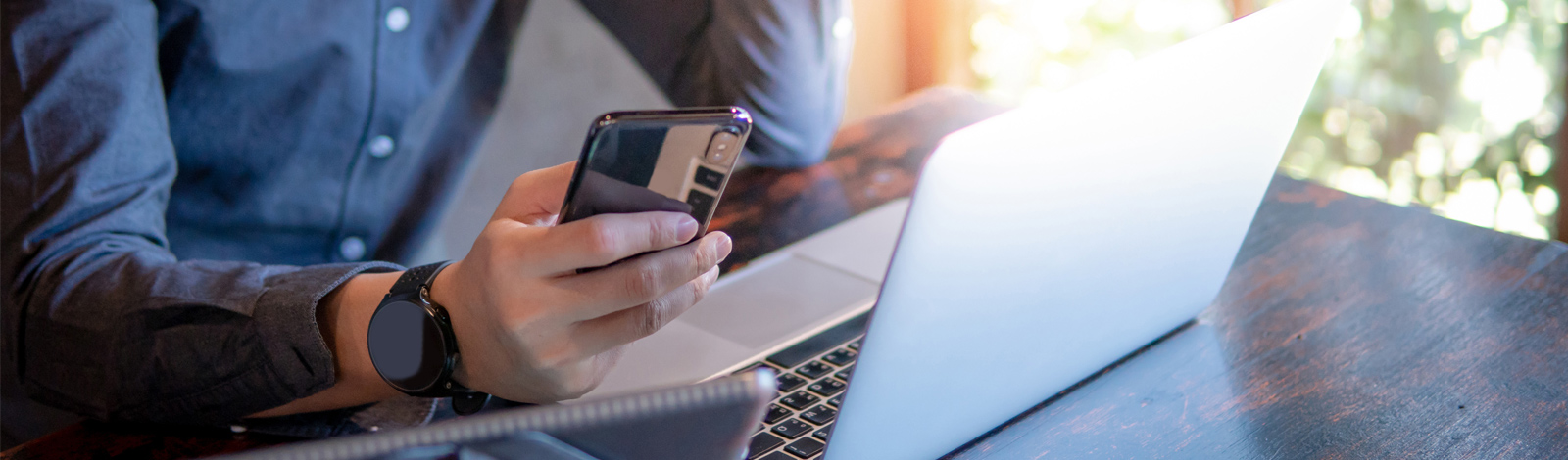 man with mobile phone and laptop