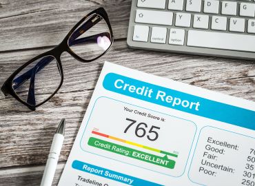 Credit report paper with pen and eyeglasses